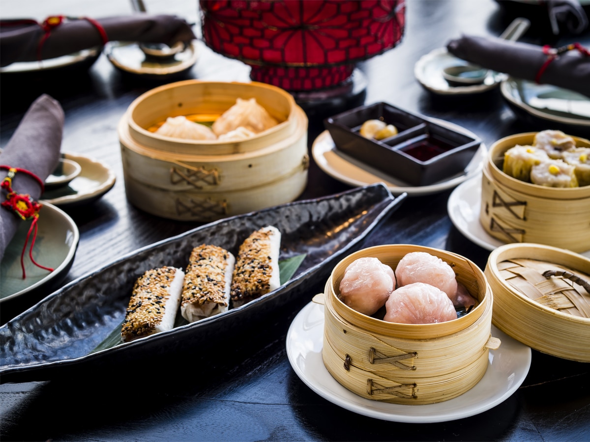 Various Chinese food on black wooden table