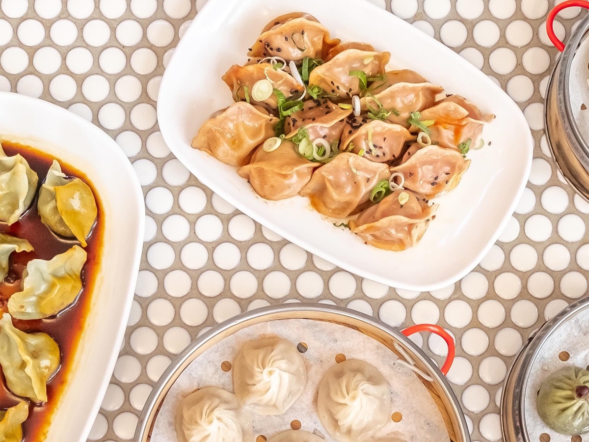 Plates of dumplings set on a patterned table