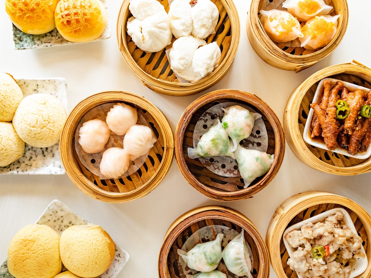 Various Chinese food on white marble table