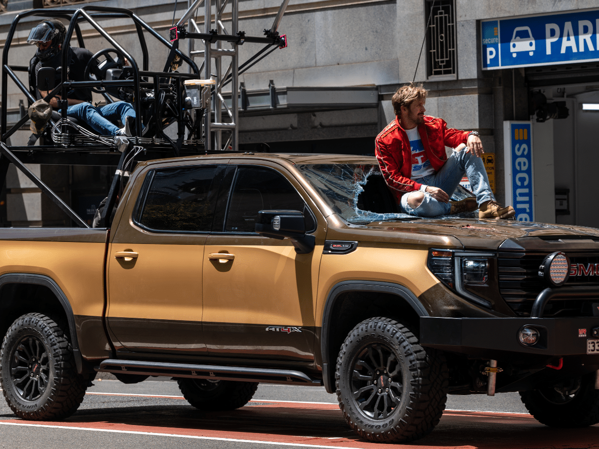 Ryan Gosling's character Colt Seavers sitting on top of the GMC truck