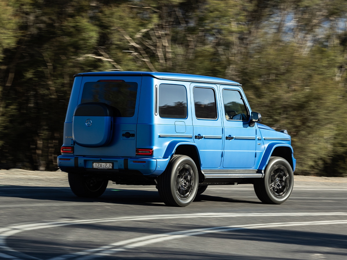 Mercedes benz g 580 with eq technology rear end driving through corner