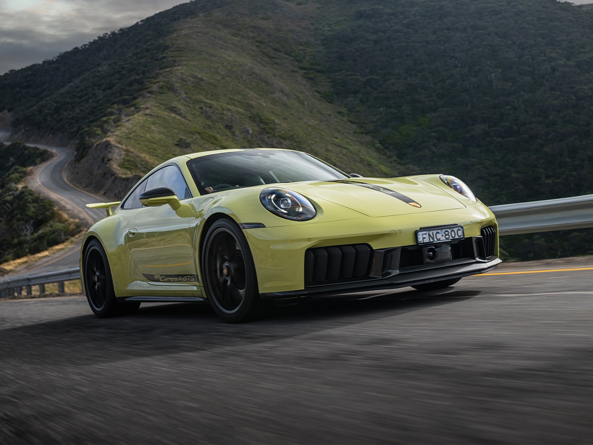 Porsche 911 carrera 4 gts front three quarter driving on road