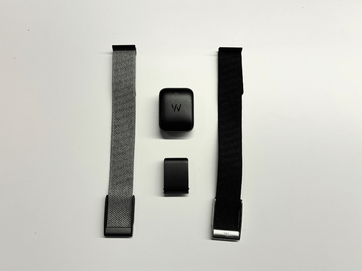 The Whoop MG, included battery pack, and two watch straps