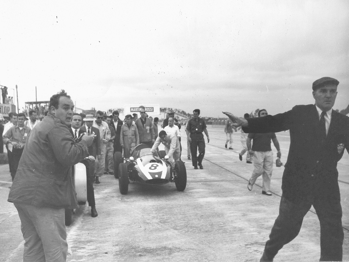Jack brabham pushing car across the line