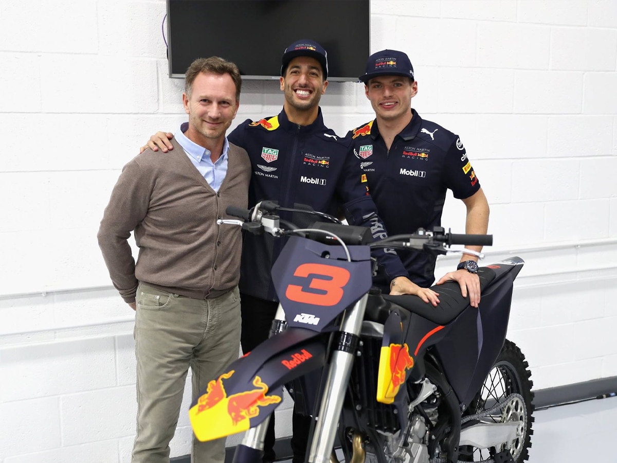 Daniel ricciardo next to bike