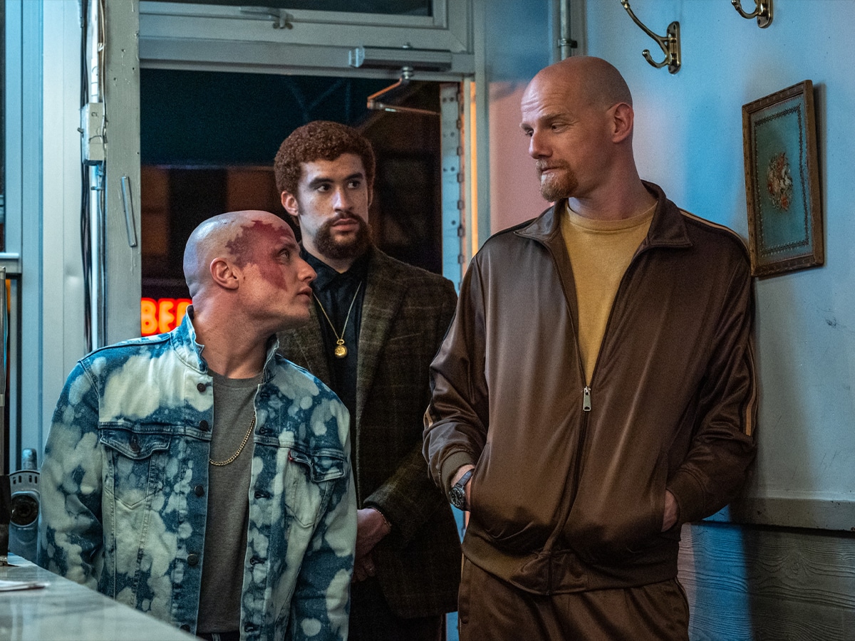 (l to r) Pavel (Nikita Kukushkin), Colorado (Bad Bunny), and Aleksei (Yuri Kolokolnikov) pay a visit to Hank in Columbia Pictures CAUGHT STEALING | Photo: Niko Tavernise