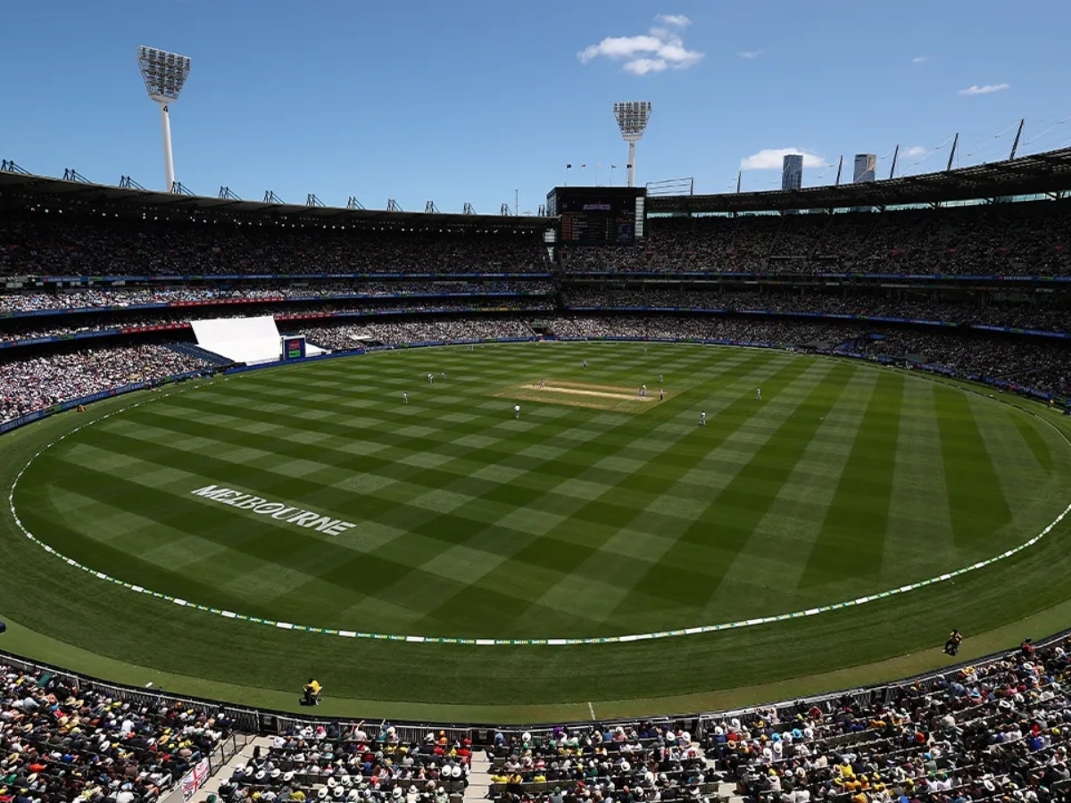 Melbourne Cricket Ground packed with spectators during a sunny day, featuring a cricket match in progress.