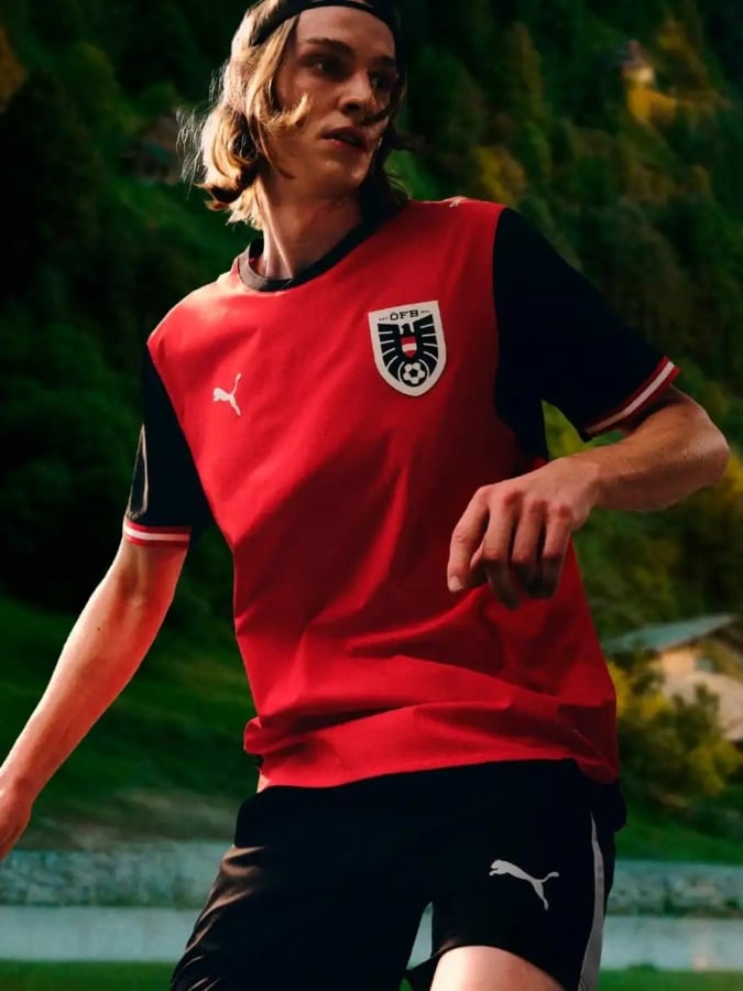 Austria 2026 World Cup home jersey by Puma in red with contrasting black sleeves and collar.