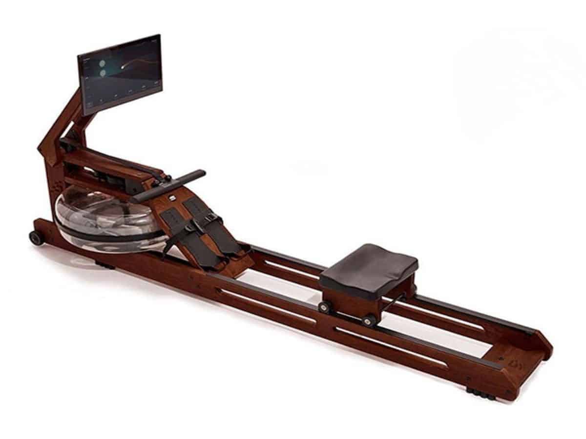 The Ergatta Rower, handcrafted from American Walnut wood, stored in its vertical position against a wall to minimize its footprint.