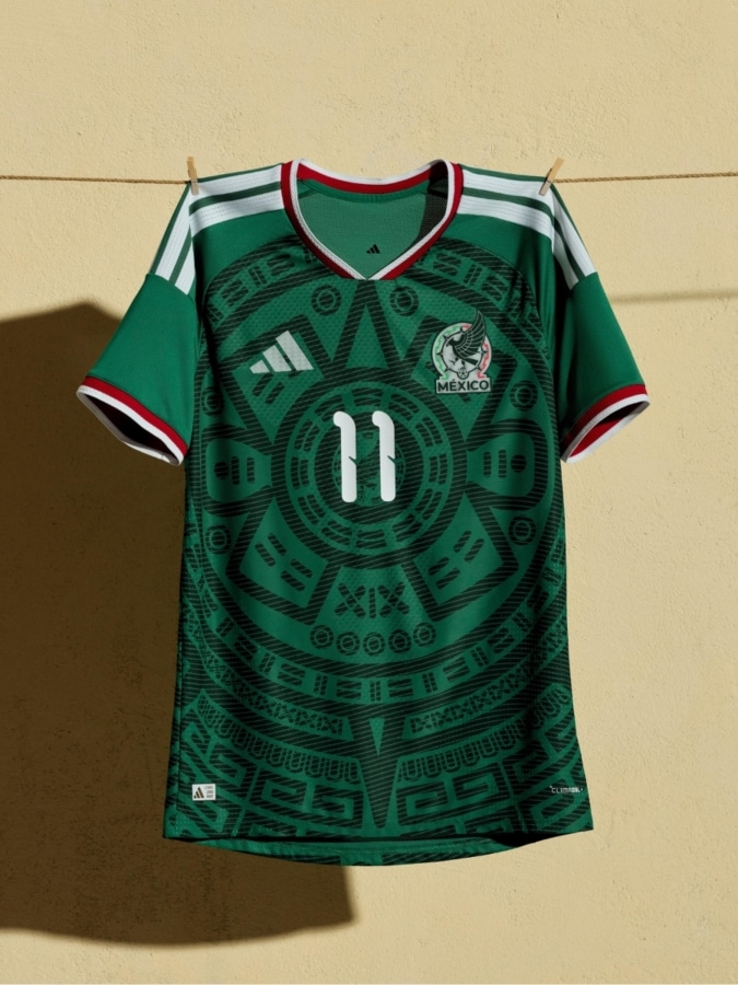 Official México 2026 World Cup home jersey in deep green featuring a tonal Aztec sunstone graphic and red trim.