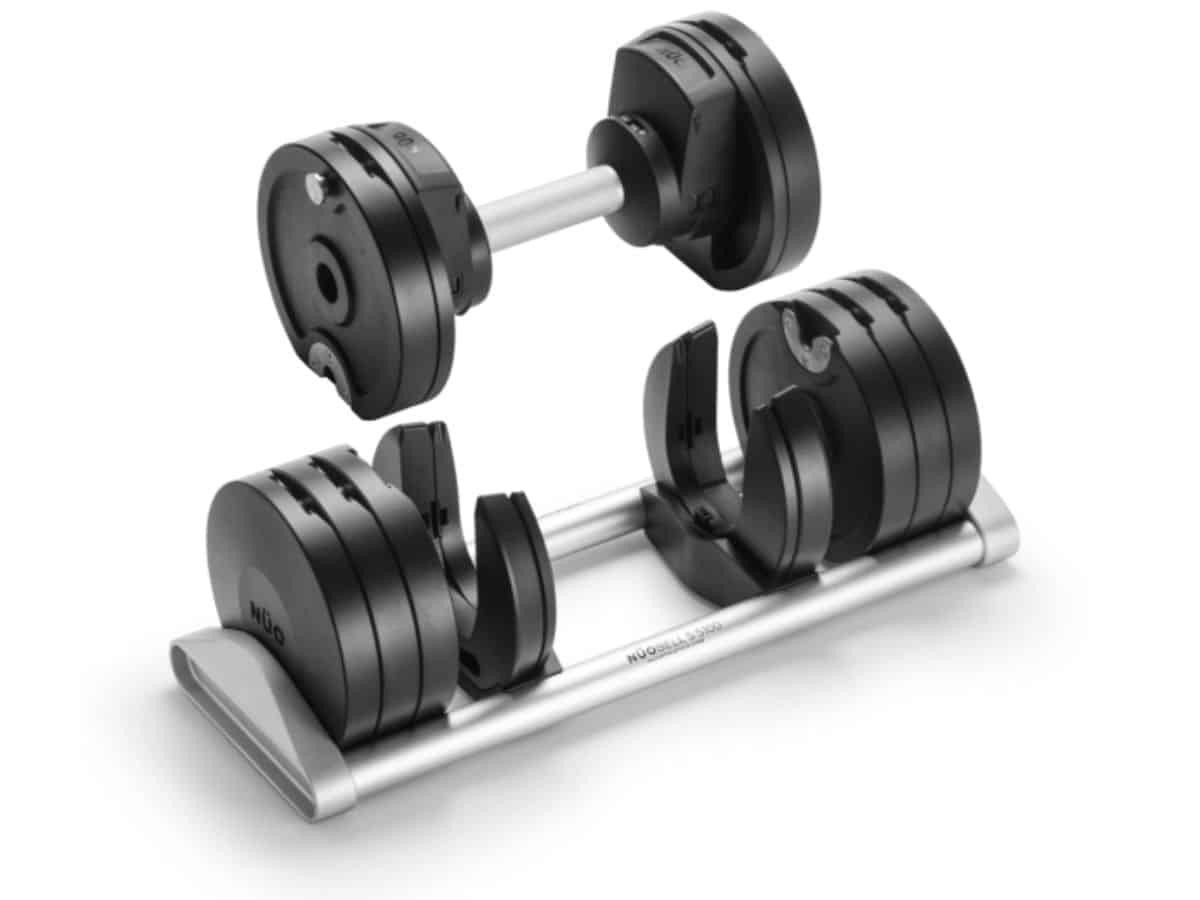 A set of Nuobell adjustable dumbbells in their housing base, showcasing the machined steel plates and knurled handles. The weight is set to 45kg.