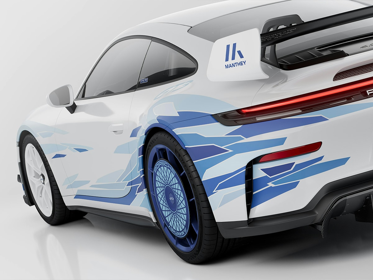 Rear end close-up showing blue carbon-fibre aero discs with Edo Kiriko pattern