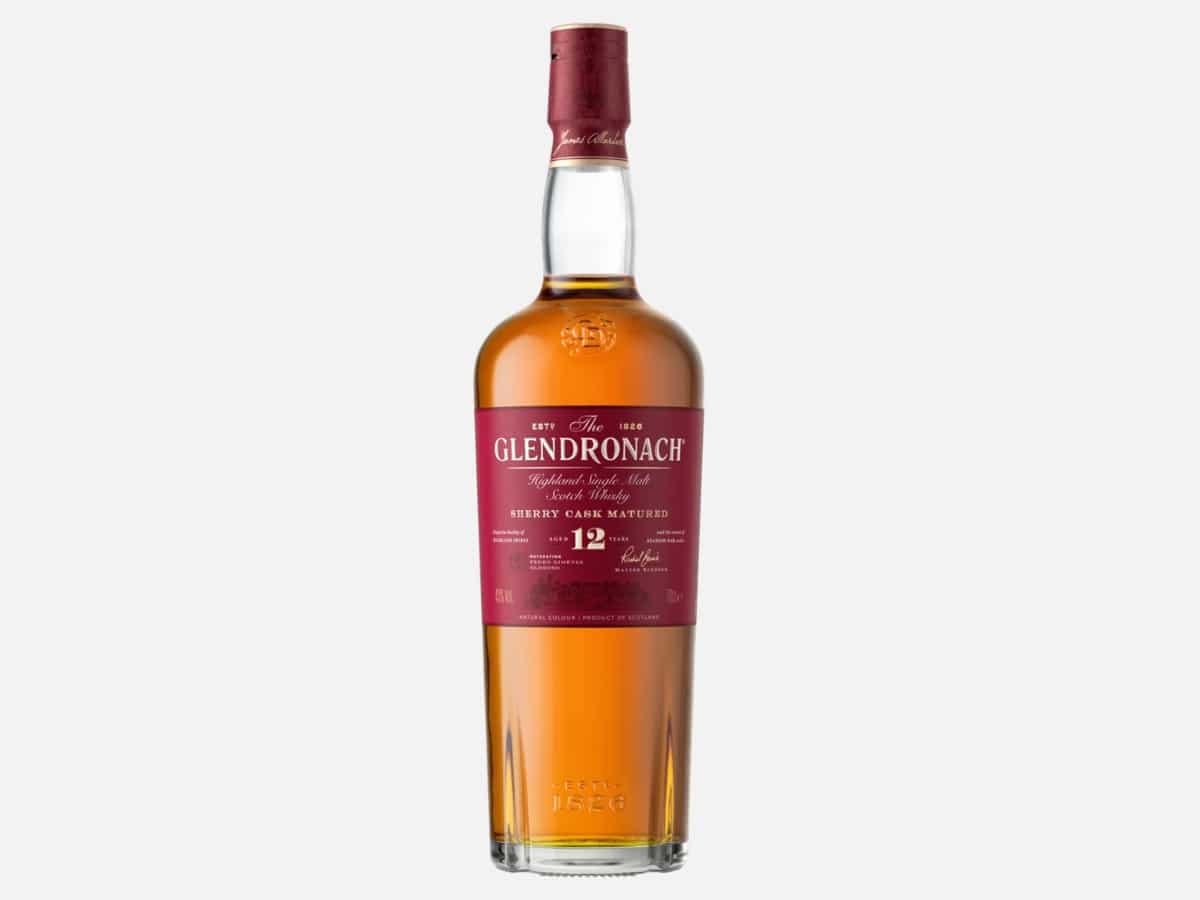 A bottle of The GlenDronach 12 Year Old Single Malt Scotch Whisky displayed alongside its deep red protective gift tube, highlighting the Highland distillery’s classic branding.