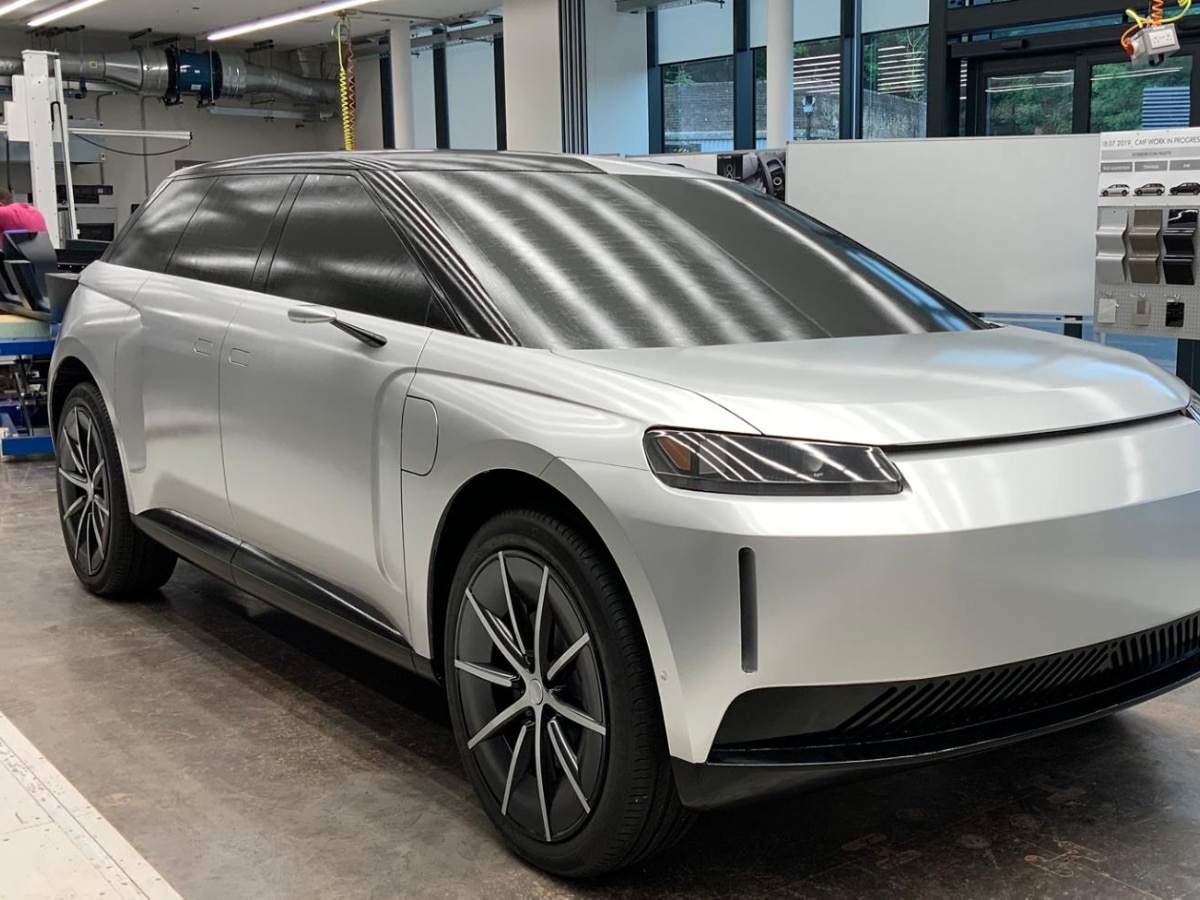 Side profile view of the sleek, grey cancelled Dyson Battery Electric Vehicle prototype concept car in a studio