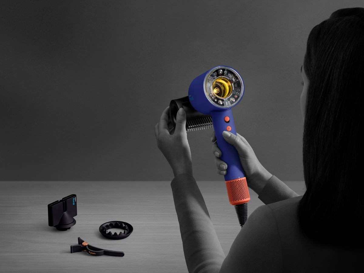 Close-up profile view of the Dyson Supersonic Nural intelligent hair dryer on a solid background, showcasing its sensor-activated capsule end
