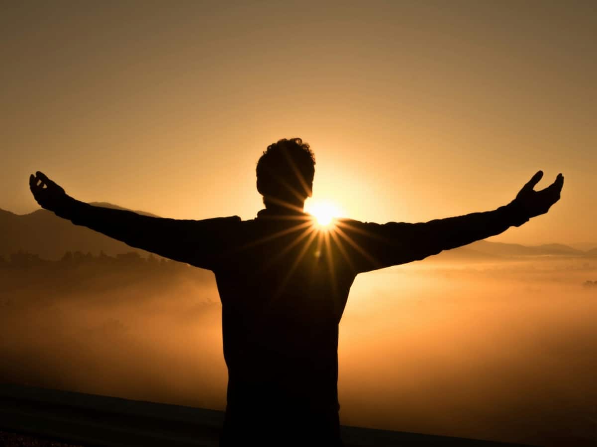 Men's health a man standing facing the sun