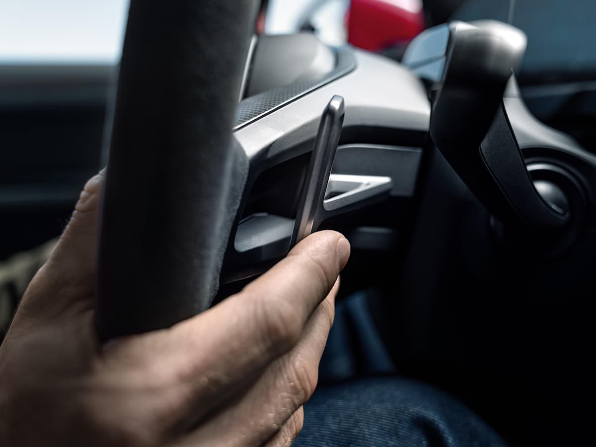 Porsche e shift hand behind wheel