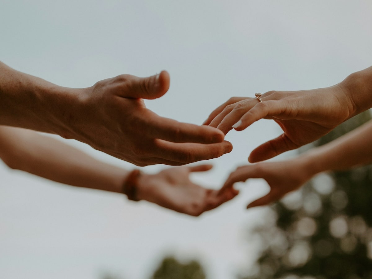 Couple reaching out and touching hands