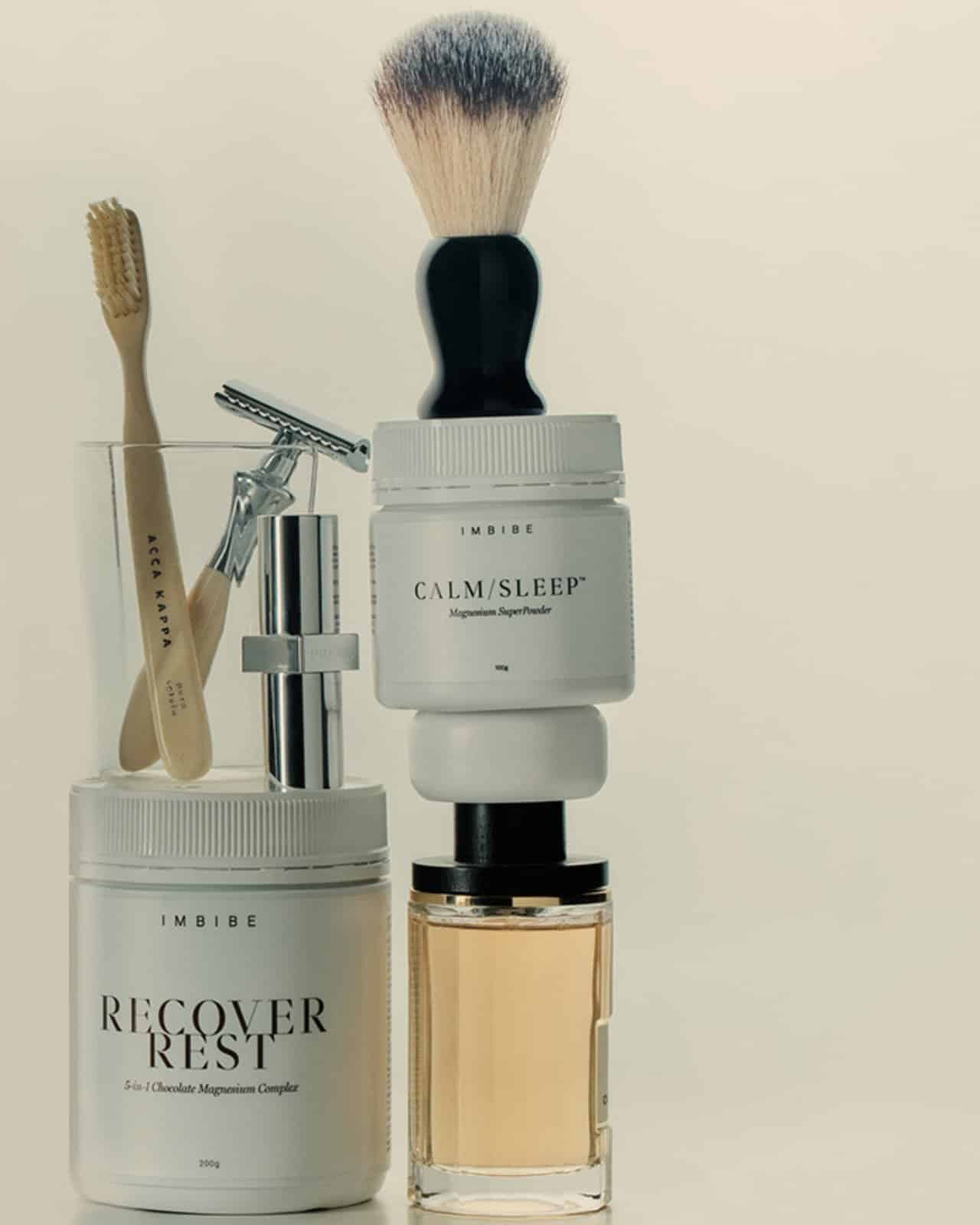 IMBIBE RECOVER REST and CALM/SLEEP tubs on a shelf with grooming items