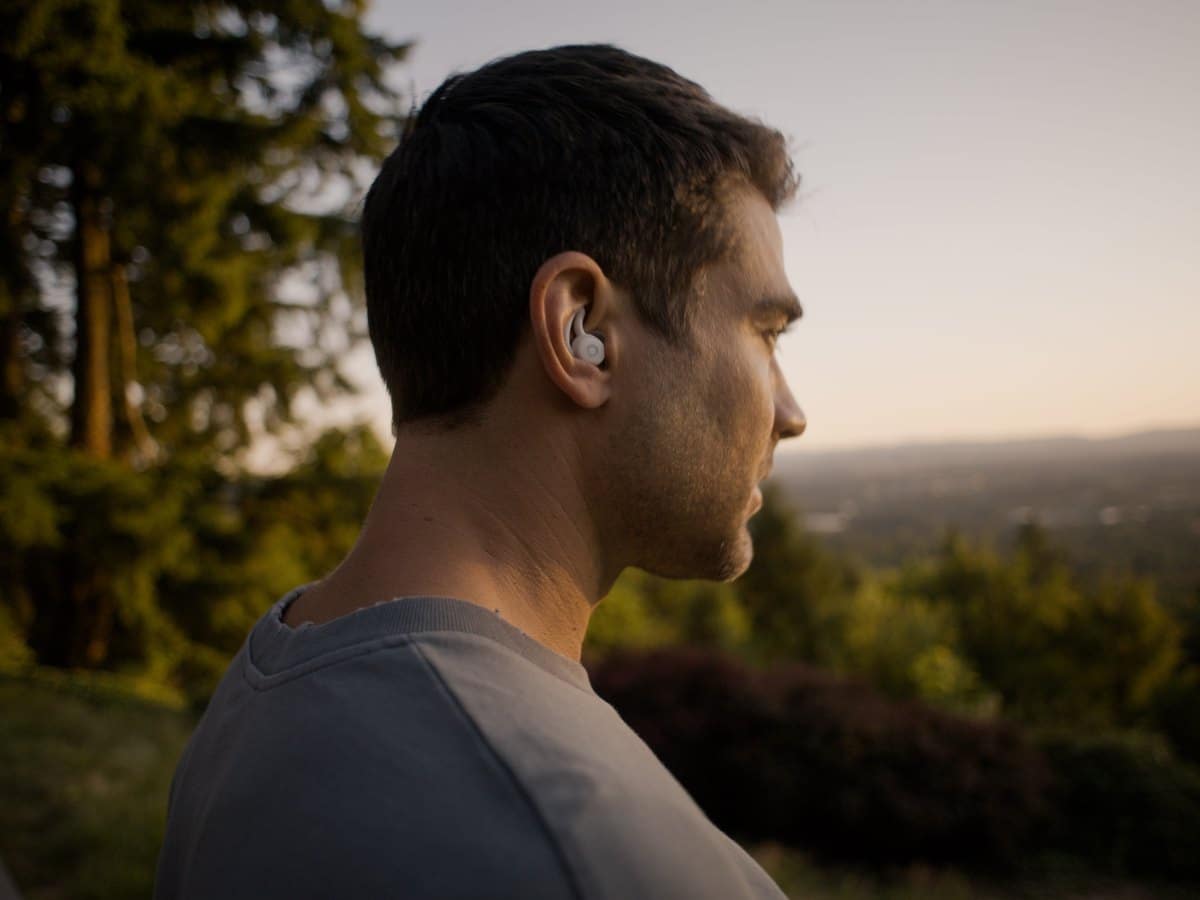 Man wearing an Ozlo Sleepbud outdoors at sunset