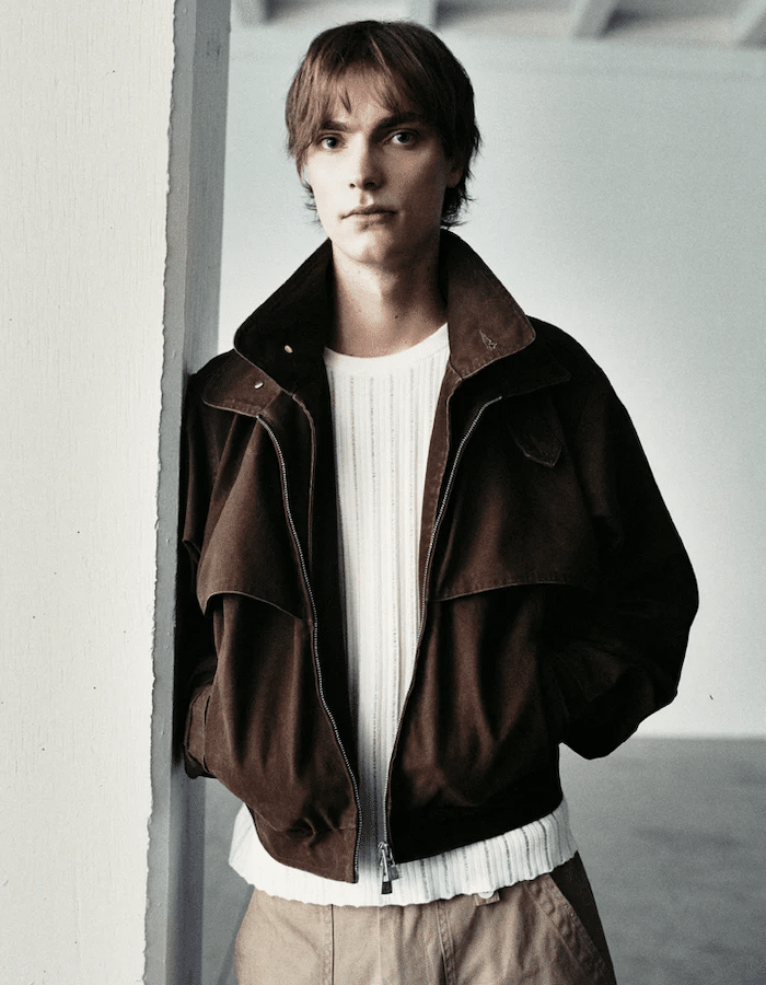 Model wearing a Porter James brown canvas blouson jacket layered over a smart button-down shirt for a men's office workwear look.
