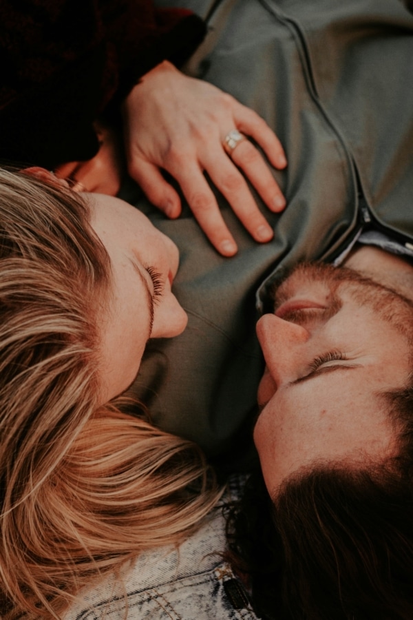 couple lying down looking into each other's eyes