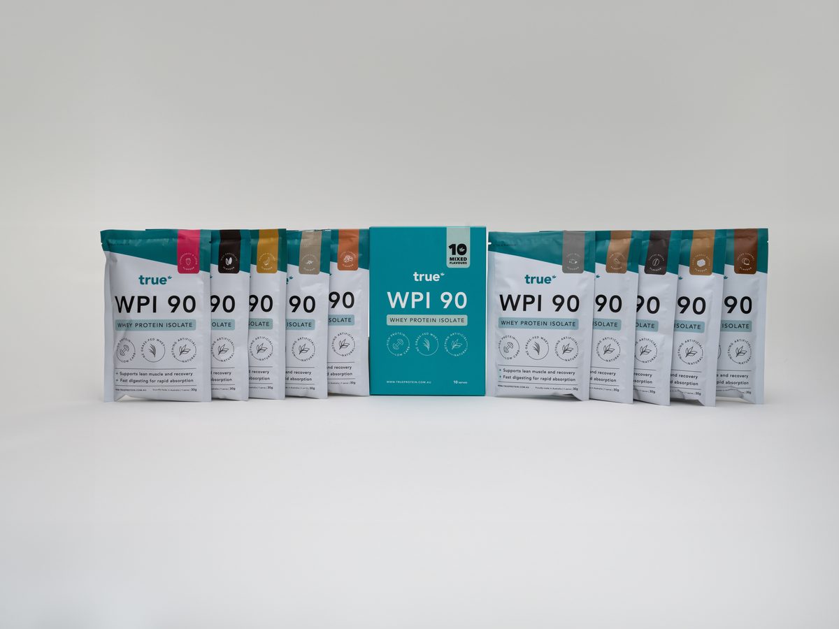 True Protein WPI 90 10-flavour sample box surrounded by individual single-serve sachets in different flavours