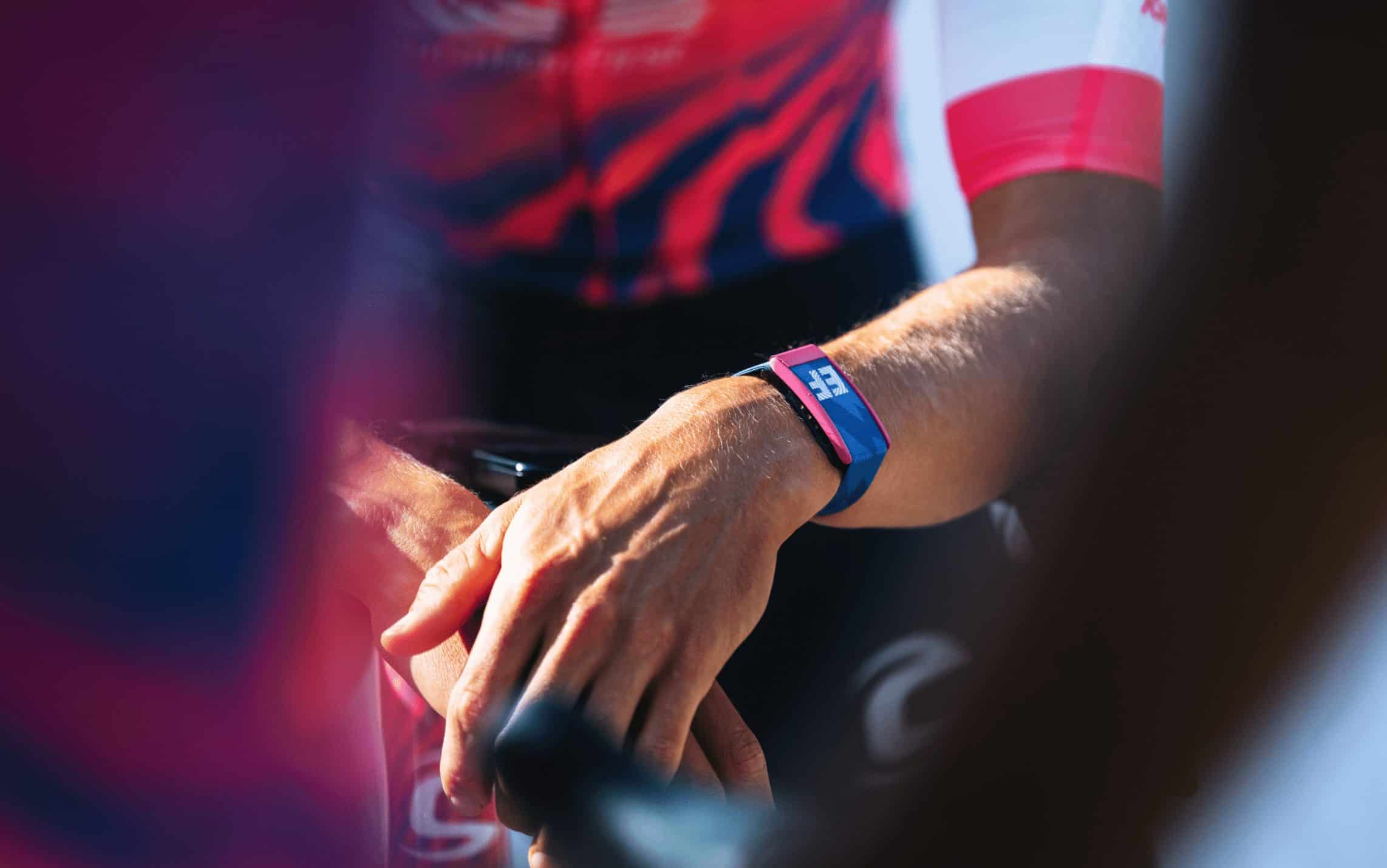 A WHOOP band worn on the wrist of a professional cyclist during training