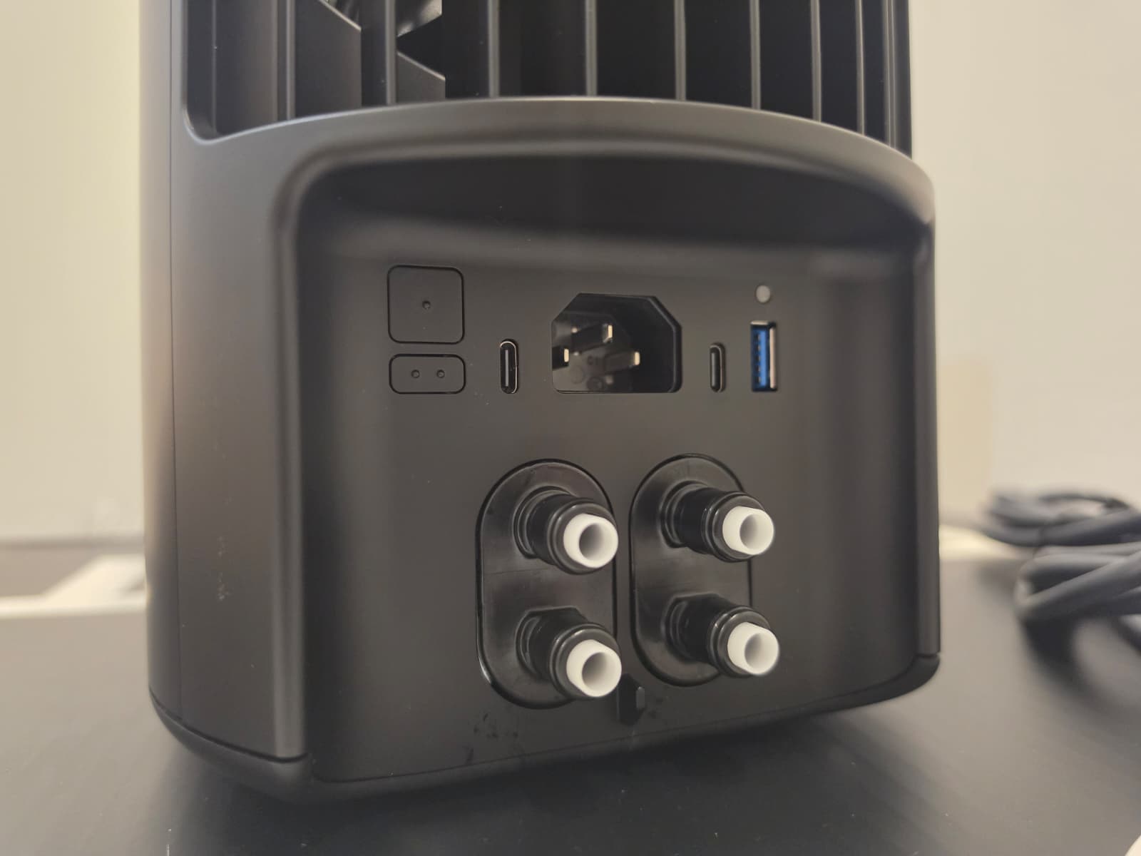 The back of the Eight Sleep Pod 5 Hub showing the power inlet, USB port and four water connectors