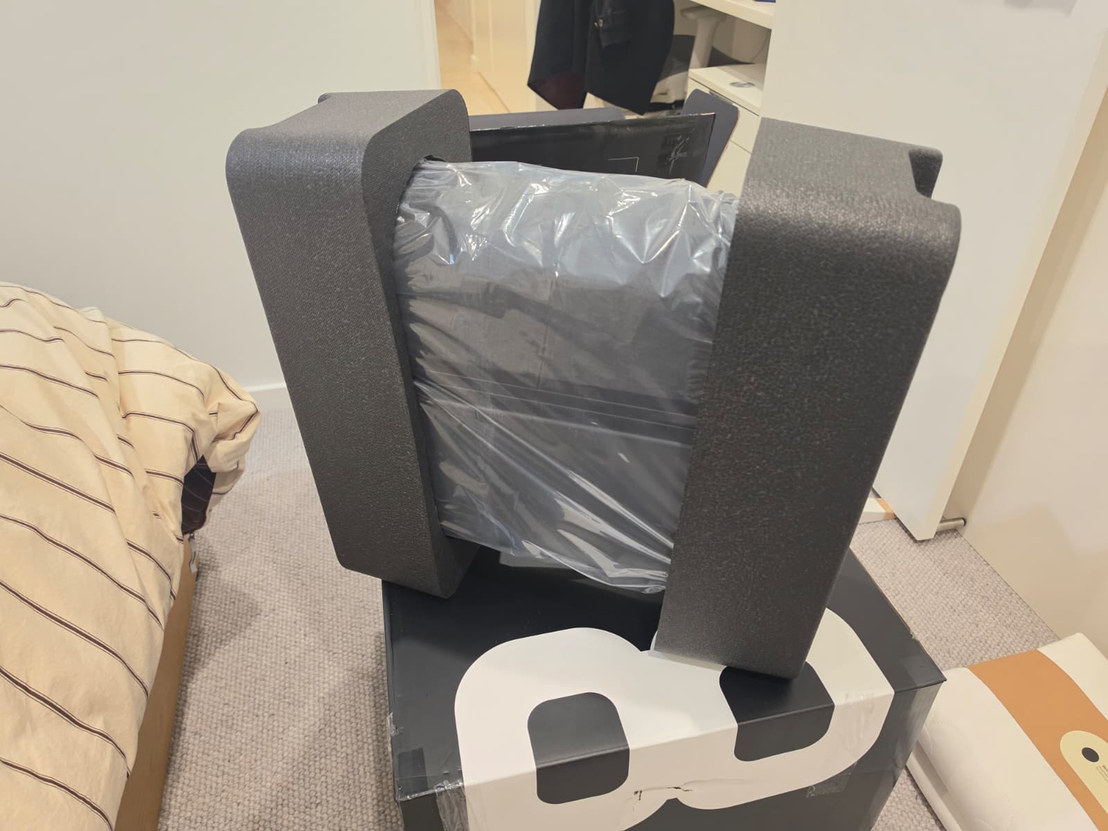 The Eight Sleep Pod 5 Hub being lifted out of its packaging