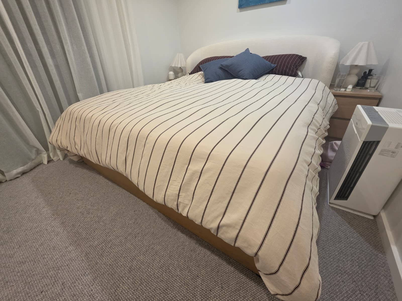 The Eight Sleep Pod 5 on a made-up king bed, shot from the side of the bedroom