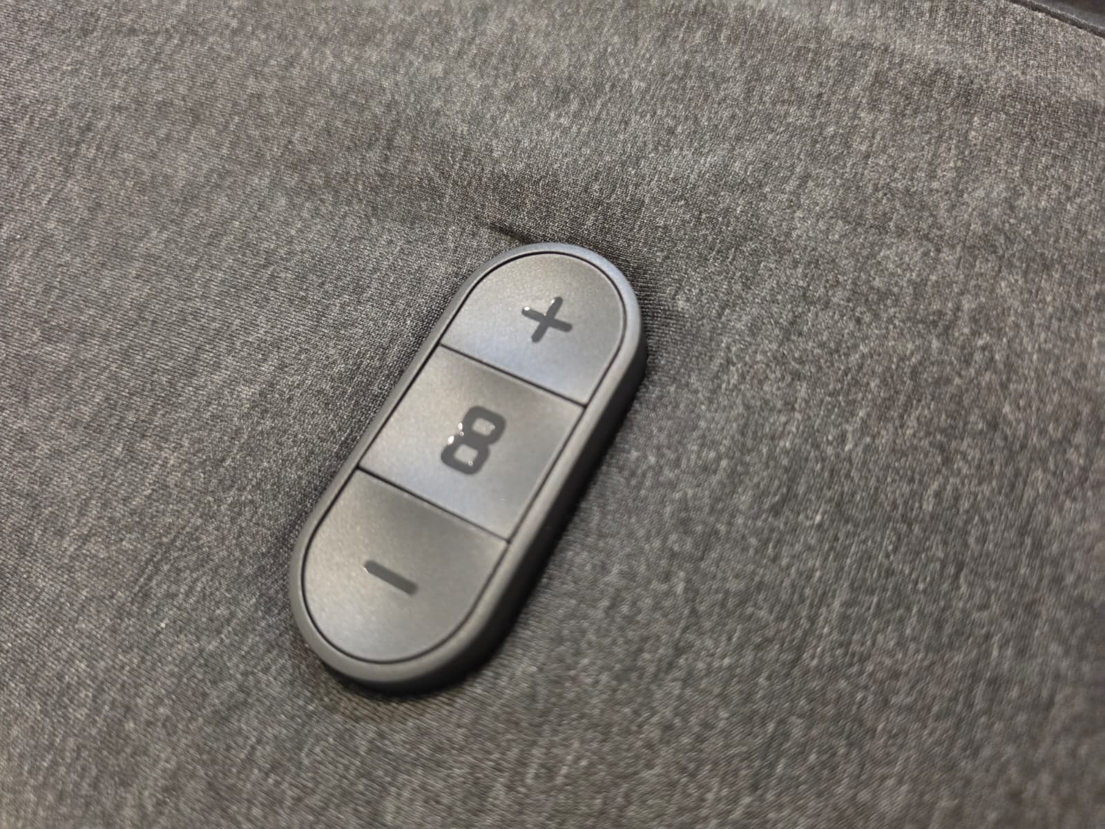 Close-up of the Eight Sleep Pod 5 physical temperature buttons on the side of the mattress
