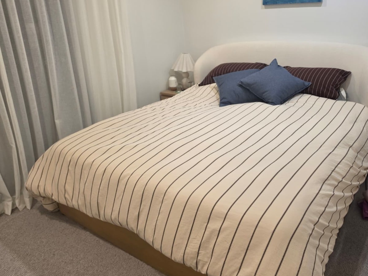 The Bonny All Rounder Quilt made up on a king bed in a bedroom