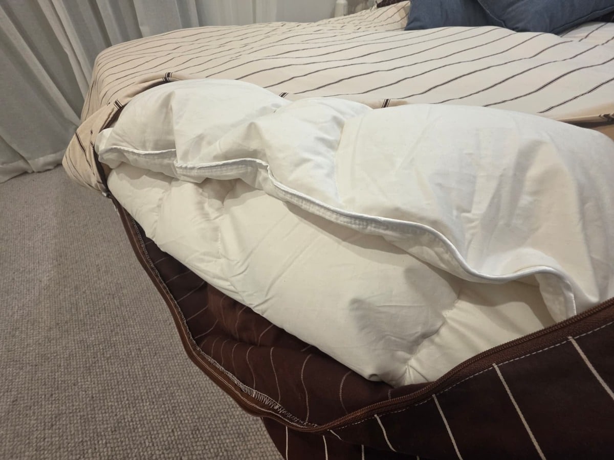 The Bonny All Rounder Quilt pulled back on the bed showing the loft of the down