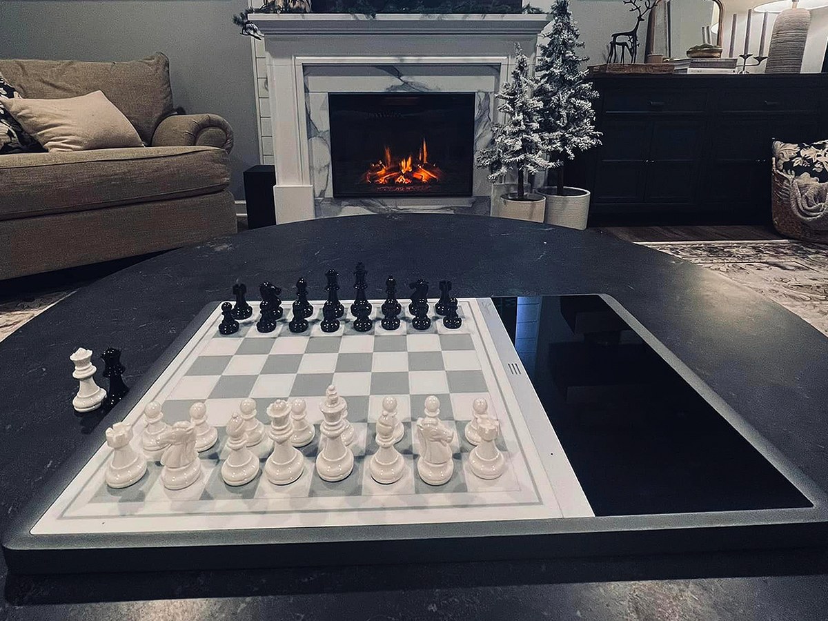 Chessnut Evo smart chess board set up on a living room coffee table