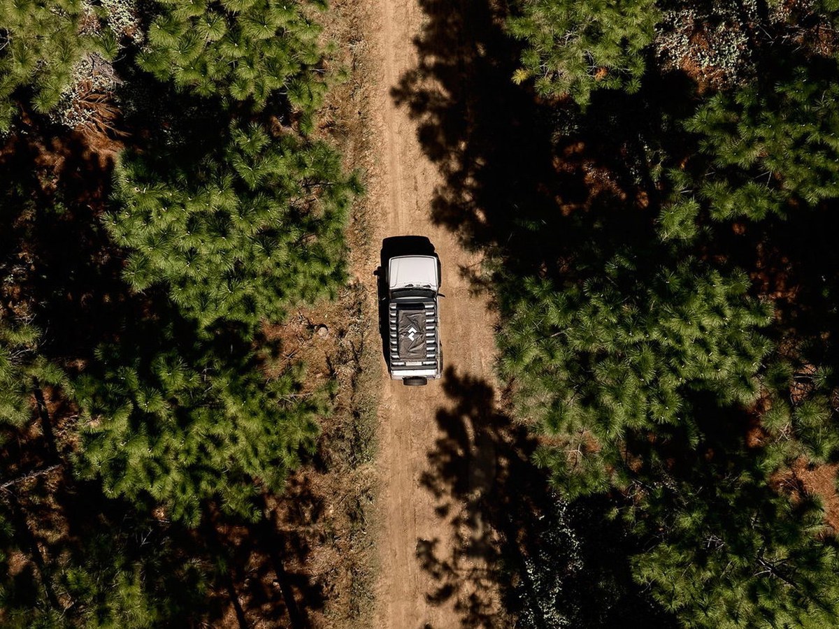 Aerial view of a Dometic equipped 4x4 with rooftop tent on a forest dirt track