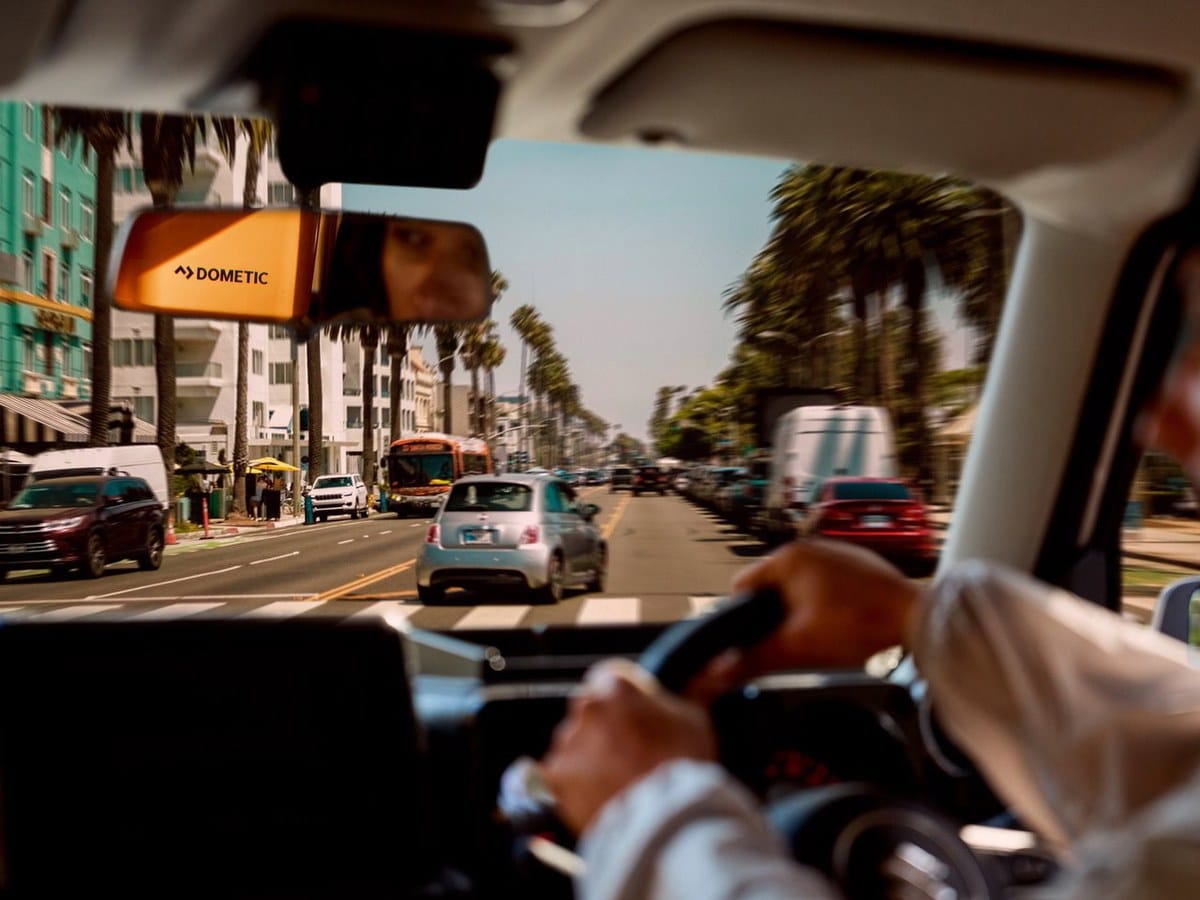 Dometic sun visor in a 4x4 driving down a palm lined coastal street
