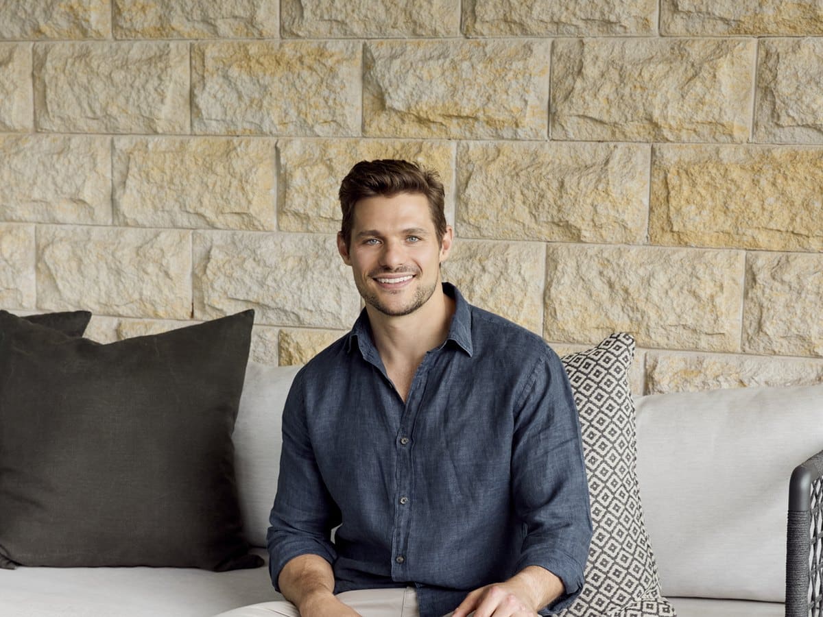 Keeper Health co-founder Angus Macintosh seated on an outdoor lounge
