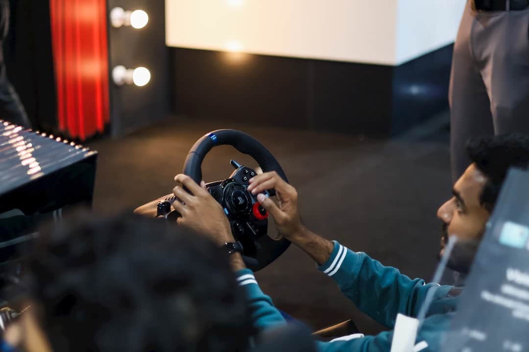 Gamer using a Logitech racing wheel and pedals