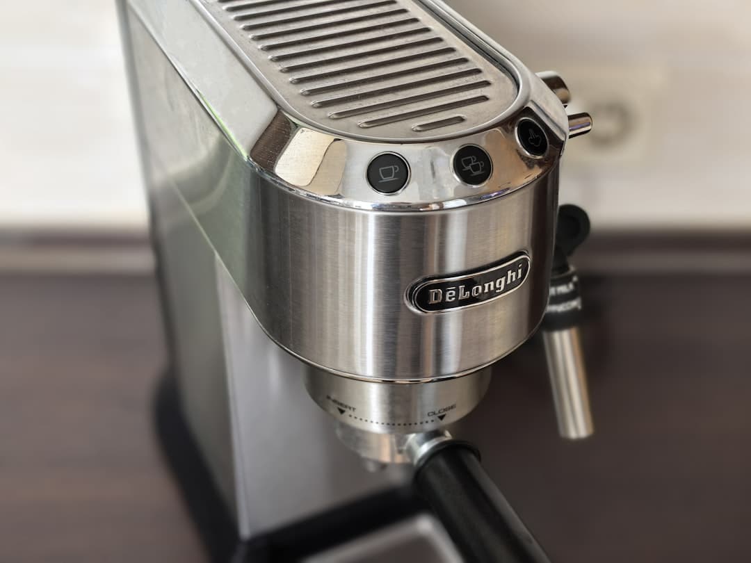 De'Longhi stainless steel espresso machine on a kitchen bench