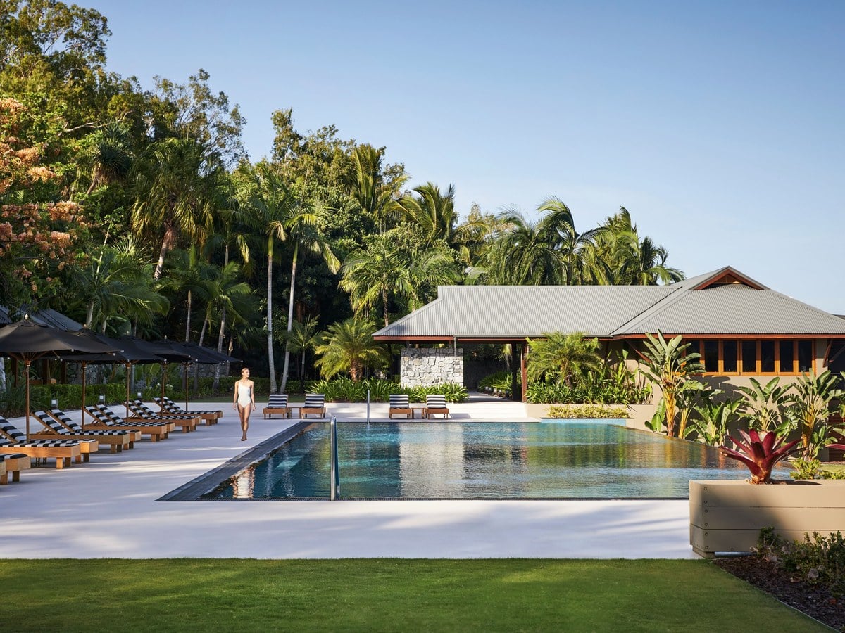 The main pool at qualia resort on Hamilton Island framed by tropical bushland
