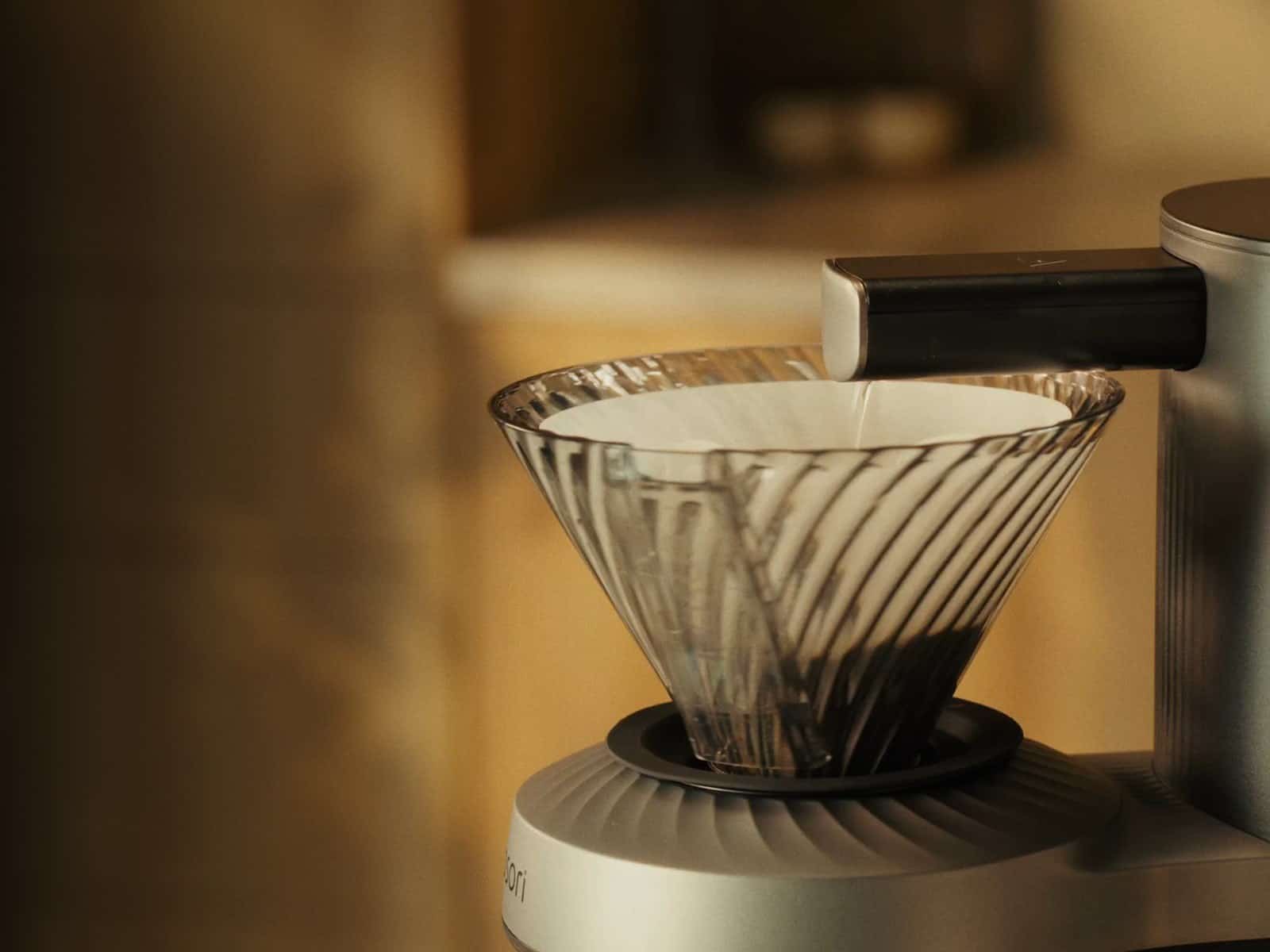 Side view of the ribbed glass dripper seated on the machine's rotating base