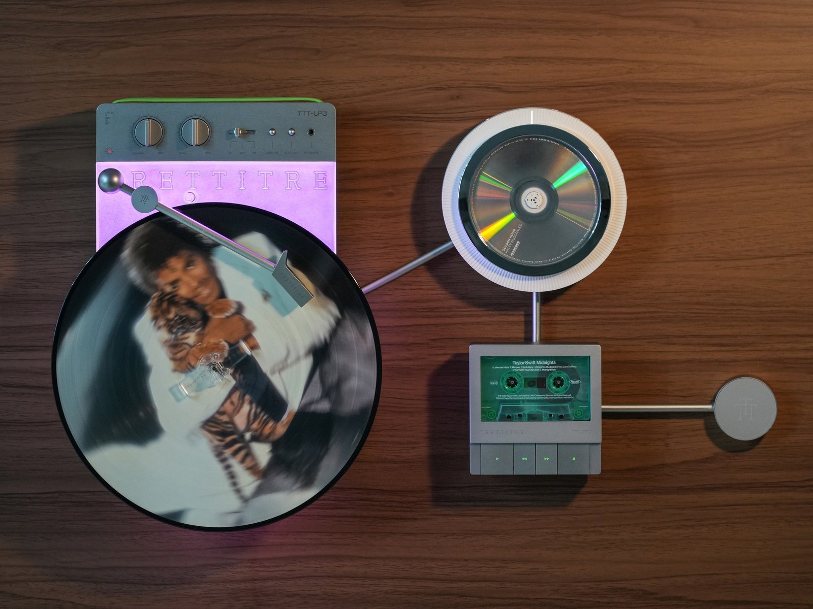 TRETTITRE Retro Wall-Mounted Ambient Audio System DP3 Bluetooth CD player on the wall with a disc spinning behind its clear front