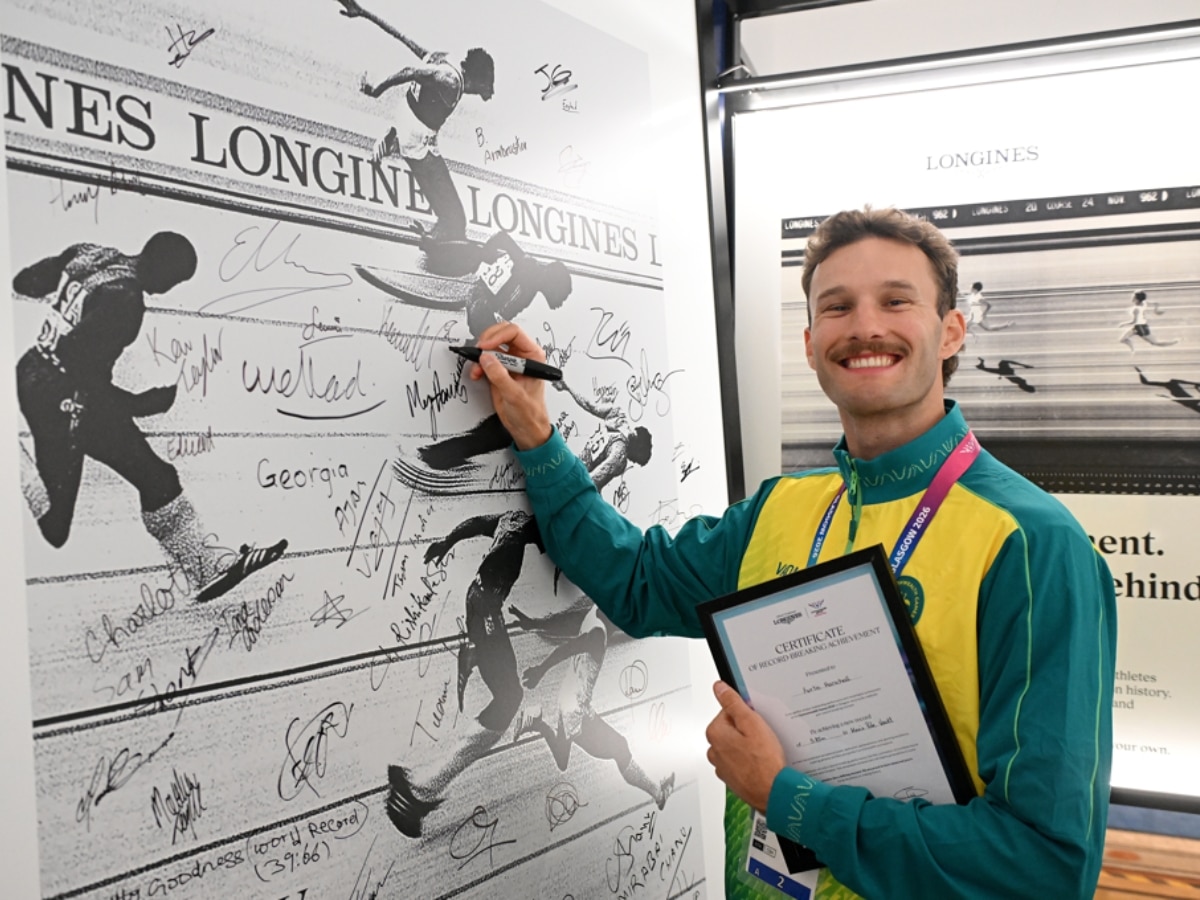 Australian pole vaulter Kurtis Marschall signing the mural at Longines House Glasgow 2026