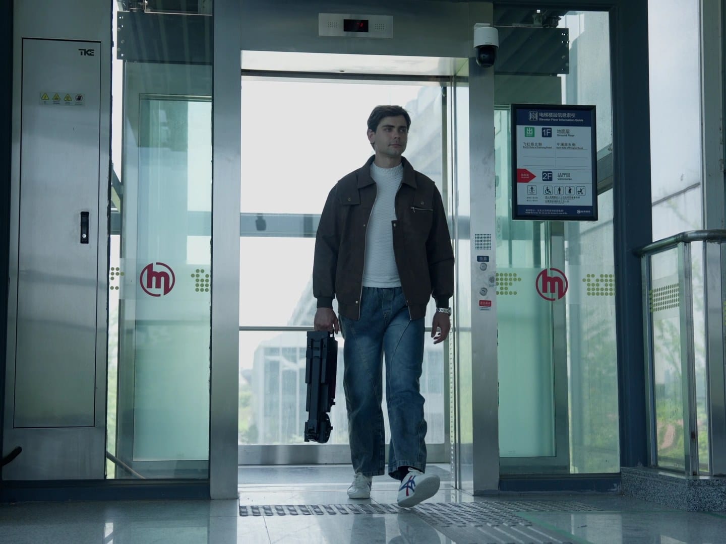 Person carrying the folded Blizwheel F0.5 electric scooter out of a metro station lift