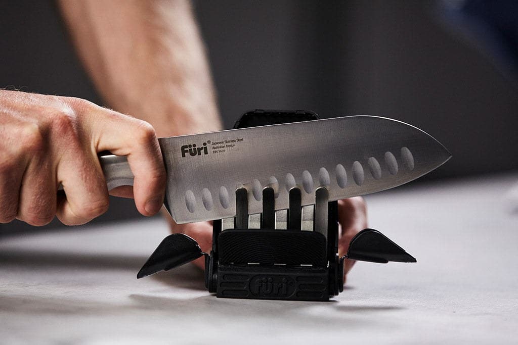 Running a santoku through the Furi Diamond Fingers Compact knife sharpener