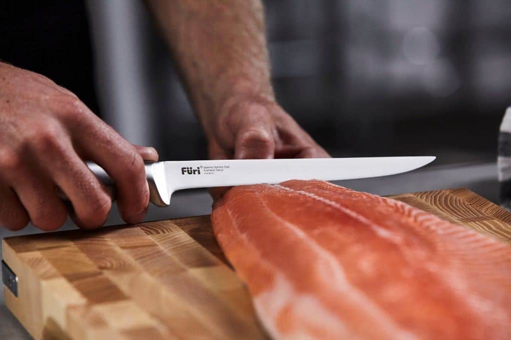 Removing the skin from a salmon fillet with a long flexible Furi blade
