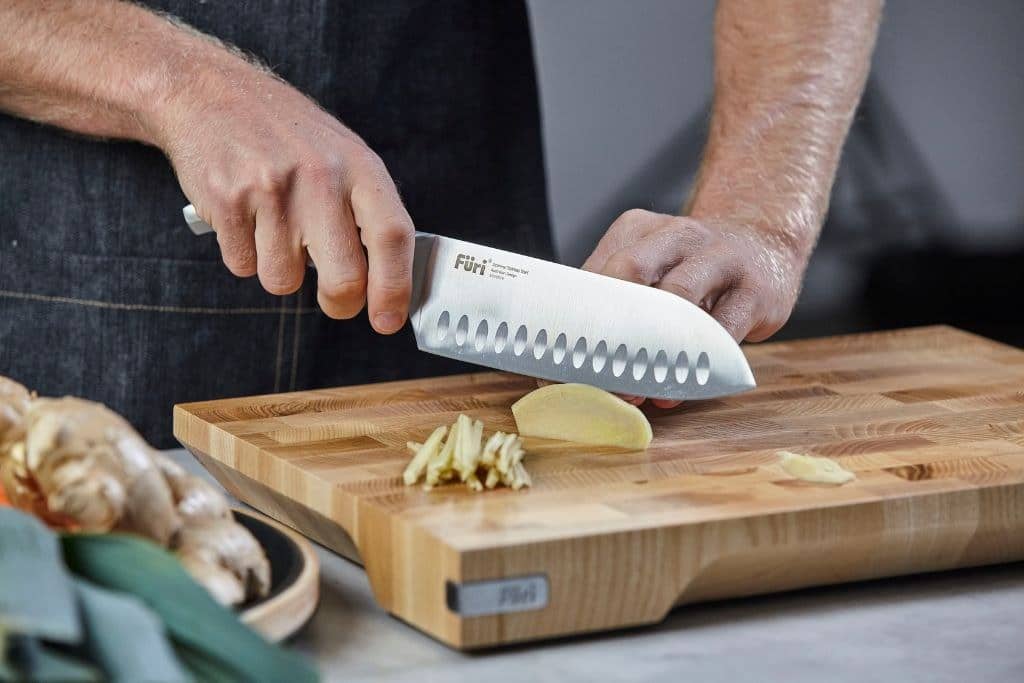 Julienning ginger with a Furi santoku knife on an end-grain board
