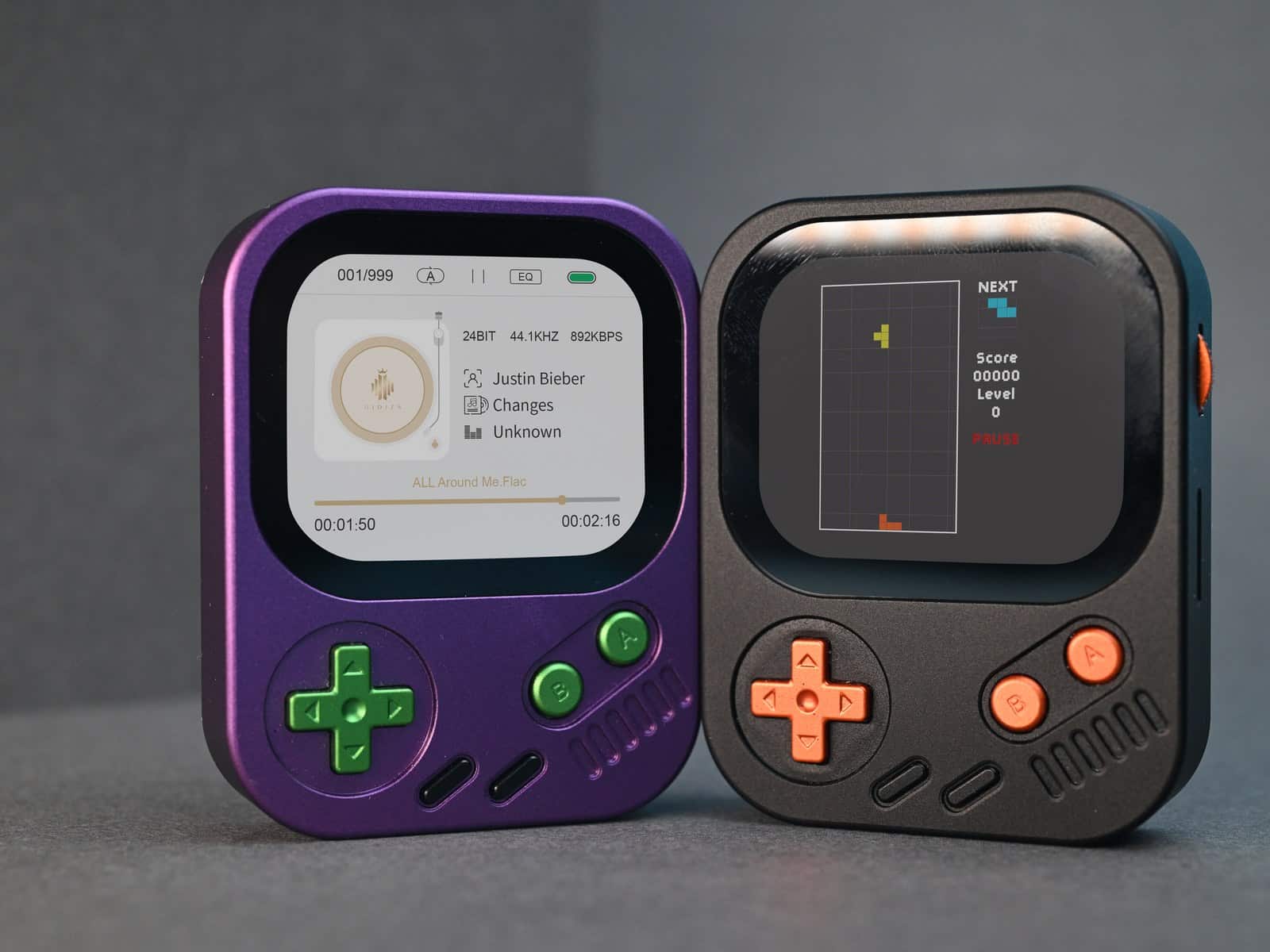 Purple and black Hidizs AP30 Music Boy units photographed front-on against a grey background, one showing a track listing and the other a game screen