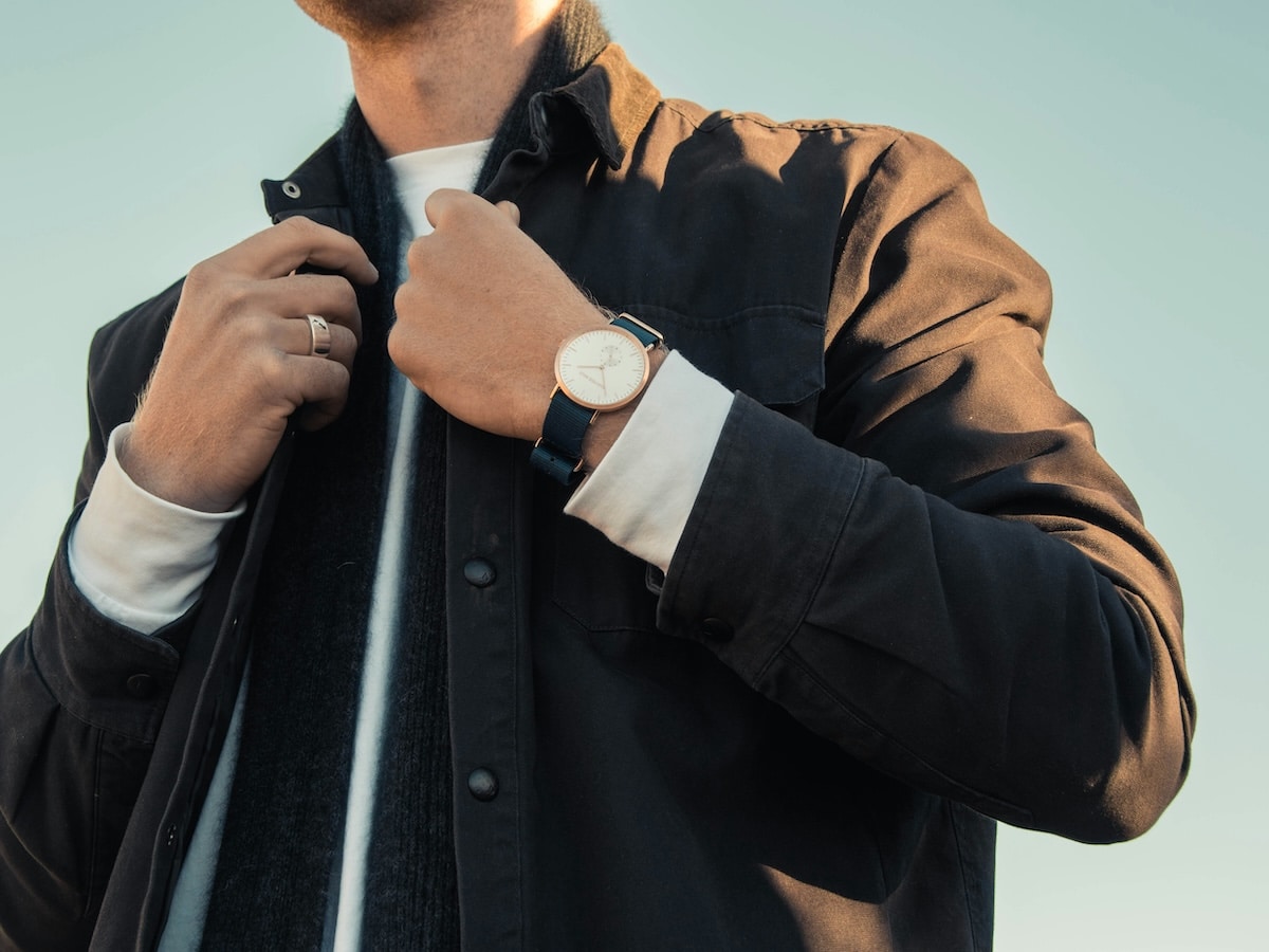 Man in jacket adjusting collar